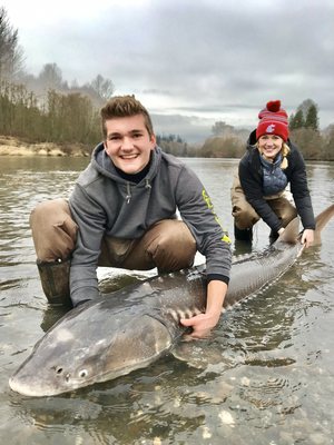 Andrew and his girlfriend with a monster 8' sturgeon!!