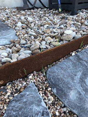 Grass growing up through the rock, everywhere that it was laid. The entire purpose of the job was to eliminate the invasive grass problem.