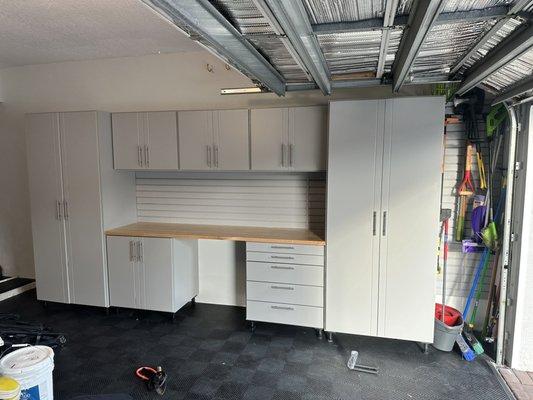 Grey cabinets with butcher block counter.