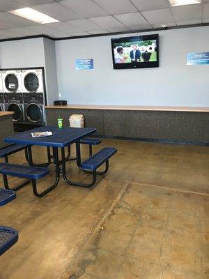 Picnic tables for relaxation while waiting for your laundry!