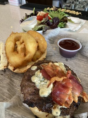 The bacon blue burger with a side salad