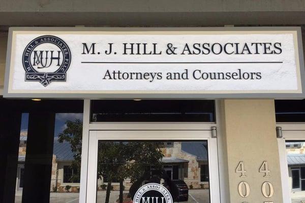 Signage from the outside office of M. J. Hill & Associates, PLLC in San Marcos, Texas