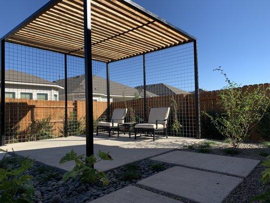 Steel and cedar pergola on a new concrete patio.