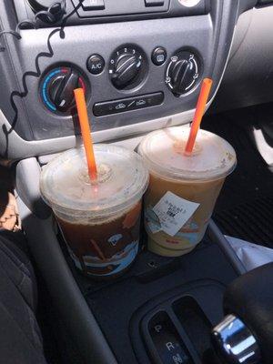 Two large caramel iced coffees, one with cream and sugar and one without either!