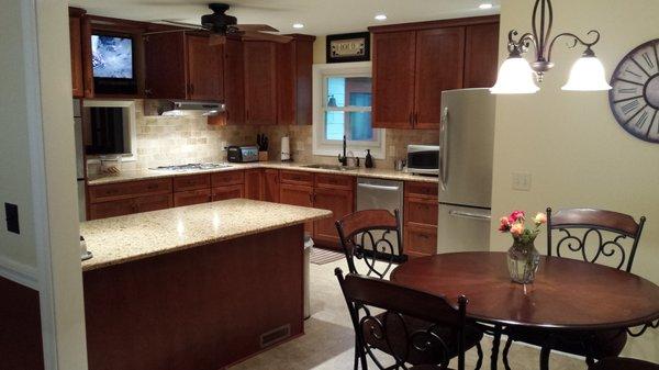 Complete kitchen remodel after the removal of two walls with cherry cabinets and granite.