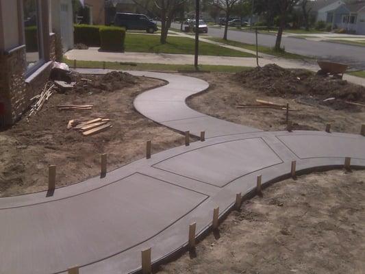 We poured sidewalks leading up to a front entryway of a Home In Lakewood