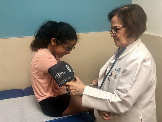 Doctor Norma B. Cornejo examining a young patient.