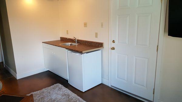 New cabinet/kitchenette and entrance door.