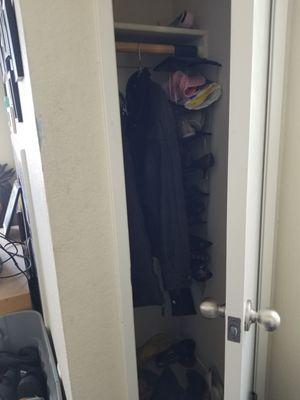 Before - cluttered entry way closet