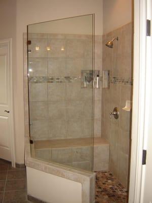 Walk in shower with frameless glass.