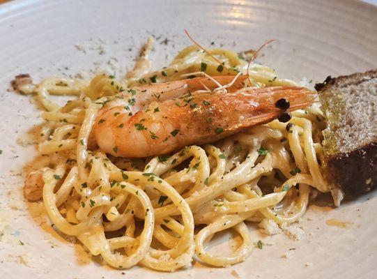 Pasta (buccatini?) with one giant shrimp.