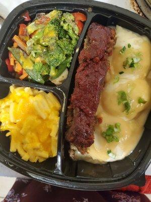 Meatloaf with mashed potatoes, Kraft dinner and old overcooked veggies.