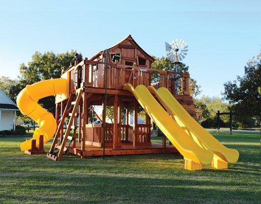 Ticonderoga playset with wrap around porch, slides, climbers and swing beam.