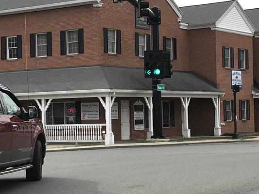 Building is right in the corner of four-way traffic lights.