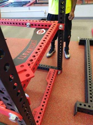 Unloading custom gym equipment from the freight truck, carrying it in, and assembling it.