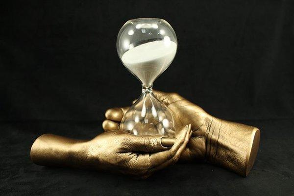 Hands holding hourglass