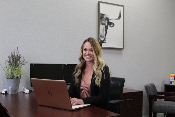 Loan Officer, Savannah Sprague, working at desk.