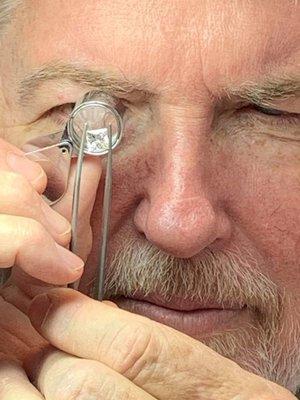 Earl Butler examining a princess cut diamond in Antwerp, Belgium, the "Diamond Capital of the World".