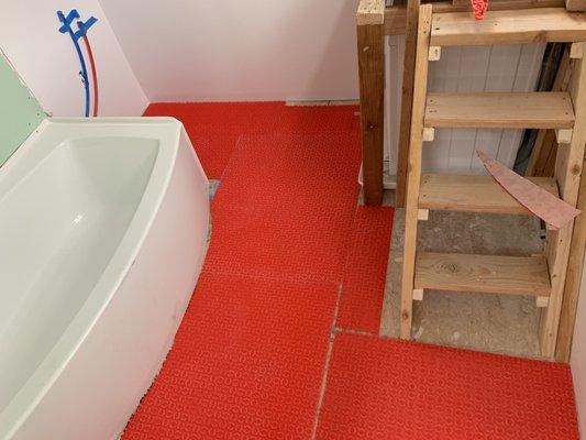 Peel and stick membrane in bathroom.