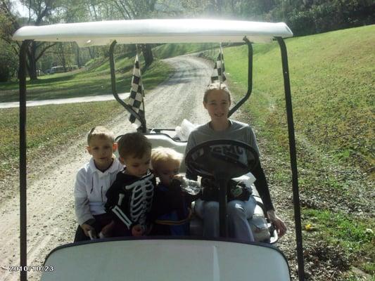 Mommy and boys riding the  golf cart she loves doing things with her boys she is a wonderful Mother