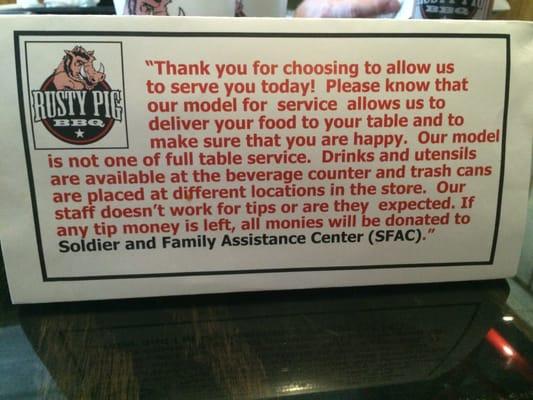 The placard describing The Rusty Pig's service model. Good to know.