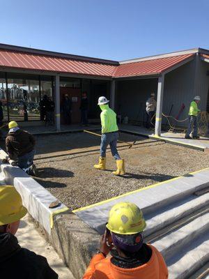 Concrete class pours front entrance of campus building