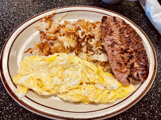 Two eggs(scrambled), hash brown and apple sausage.