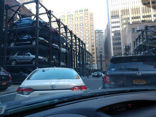 The empty high rise spots with cars completely blocking the lot entrance.