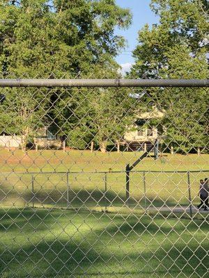 There is a basketball goal/mini track. That hill is perfect for sliding on cardboard and many a kid has slid down that hill including me.