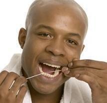 Man Flossing, Teeth Whitening in Hershey, PA