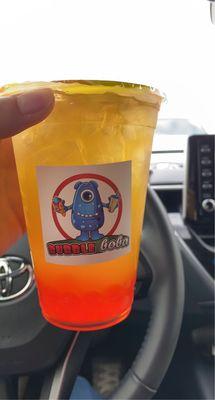 Mango clear tea with strawberry popping boba