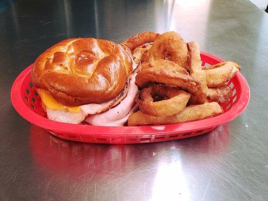 Our 8 ounce baked ham and cheese sandwich on a buttered Pretzel Bun with our beer battered onion rings!