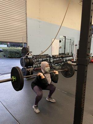 Doing barbell front squats.