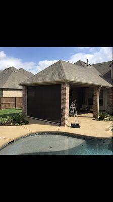 Patio cover with motorized solar screen , to screen the harsh western sun .