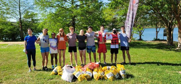 Our group from university proud of the many pounds of trash they have just cleaned from the river.