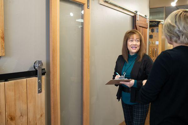 Architectural hardware salesperson helping a client  select barn door hardware in the NBH showroom.