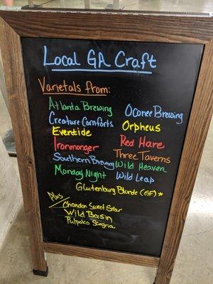 Blackboard stand showing local beer varietals offered.