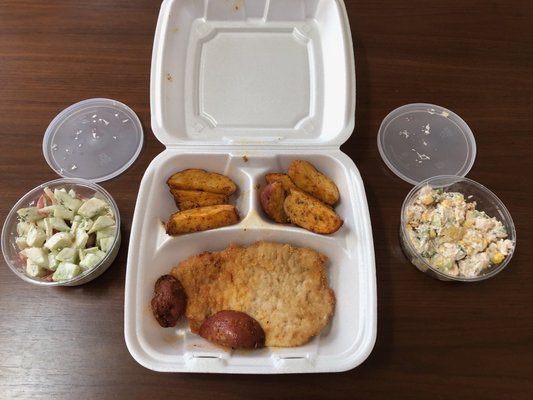 My $3.99 chef's meal - pork chop, baked potato wedges, a cucumber-tomato salad, and a Hawaiian chicken salad!