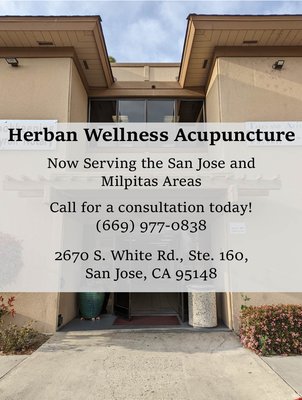 Office building entrance with Herban Wellness Acupuncture's contact information.