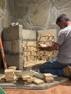 Laying the brick in a vent-free Isokern firebox. Built using volcanic rock and made to withstand years of use.