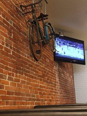 Bike on an exposed brick wall? Why not?