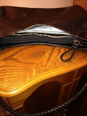 Repairman cut a seam in the leather pieces of a Cole Hahn purse in order to replace a zipper inside the lining. Cut lining only!