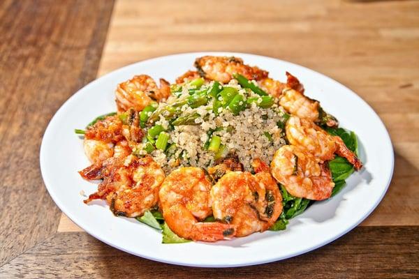 Marinated shrimp sautéed and served over quinoa, asparagus, green beans, spring onions, and lemon vinaigrette mixture on spinach and kale.