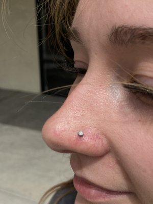 Nostril piercing with bezel set moonstone gem