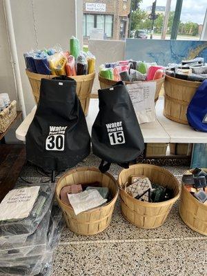 Selection of bags, art supplies for sale