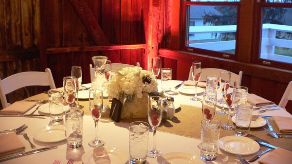 Custom red uplighting compliment the raspberries adorning the tables.