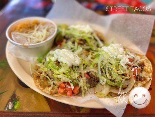 Lengua, shredded beef & carnitas tacos with upcharge for lettuce, tomatoes, sour cream & grilled onions (w/rice & beans)