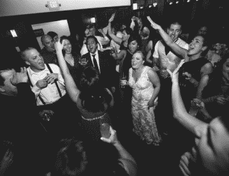 bride on dance floor with friends and family