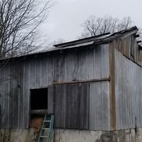 Old barn before we installed a new metal roof and a deck.