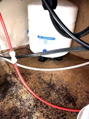 Faulty installation of water softener in March, sitting in a puddle, cupboards rotting, leaking plumbing, no water to fridge/icemaker.